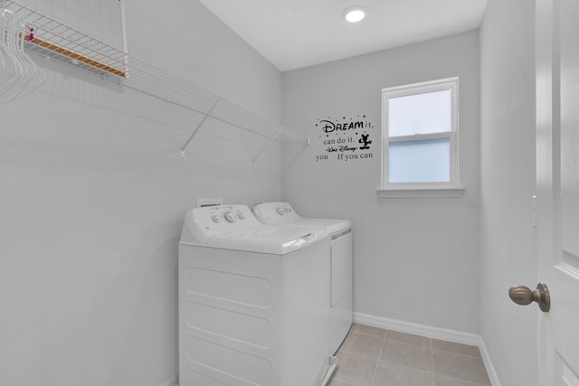 washroom featuring washer and clothes dryer and light tile patterned floors