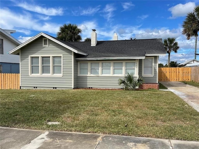 ranch-style house with a front lawn, fence, crawl space, and a chimney