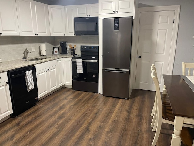 kitchen with sink, black appliances, and white cabinets