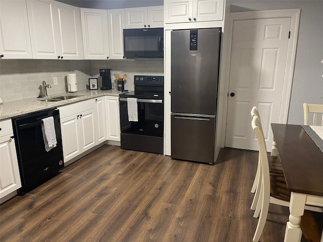 kitchen featuring a sink, light stone countertops, black appliances, and white cabinetry