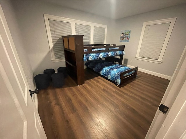 bedroom featuring baseboards and wood finished floors