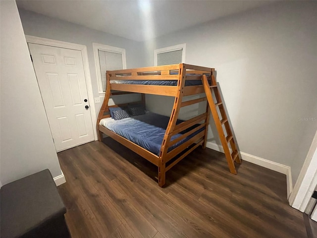 bedroom with a closet and dark hardwood / wood-style floors