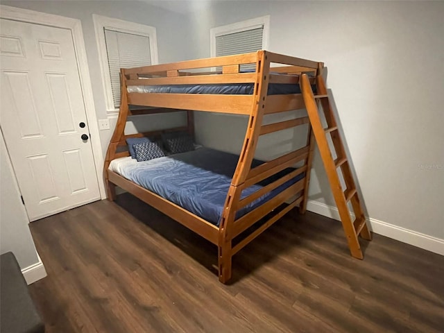 bedroom featuring dark wood-type flooring and a closet