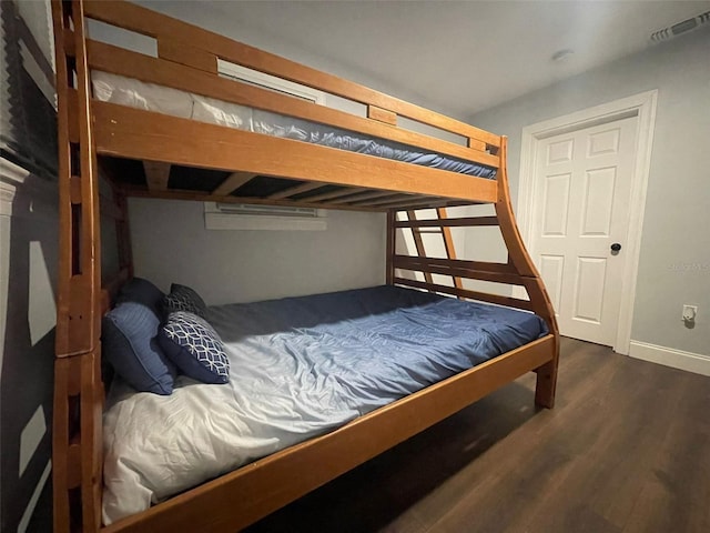 bedroom with visible vents and wood finished floors