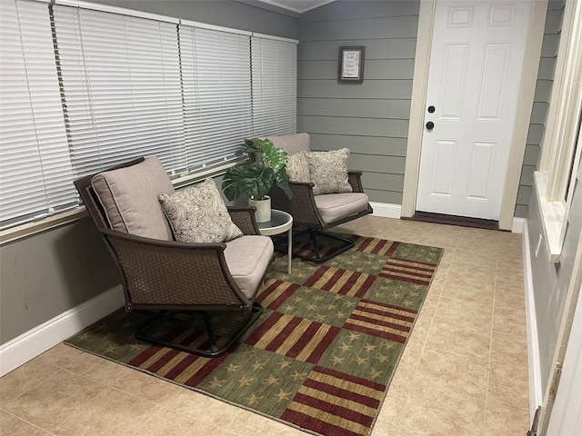 sitting room with baseboards and tile patterned flooring