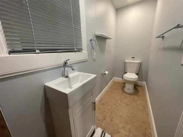 bathroom with vanity, toilet, and tile patterned flooring