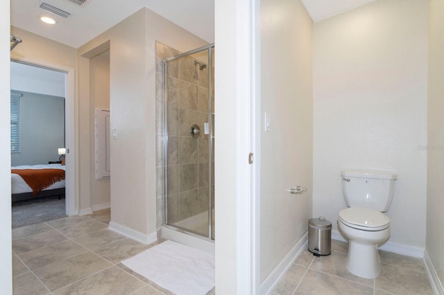 bathroom with a shower with door, tile patterned floors, and toilet