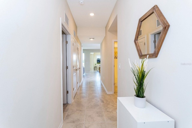 hallway featuring light tile patterned flooring