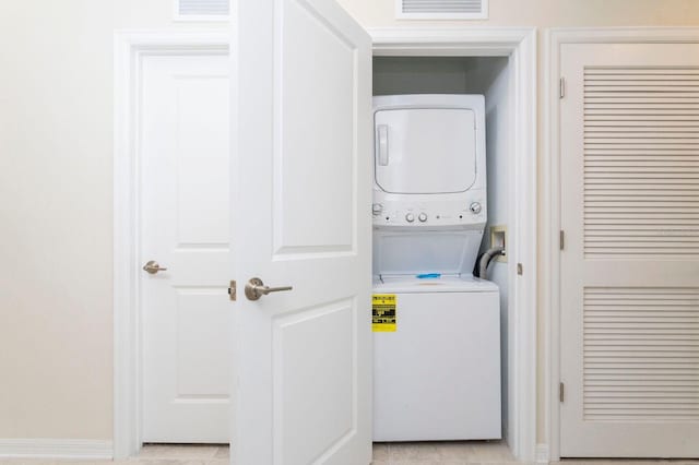 laundry area with stacked washing maching and dryer