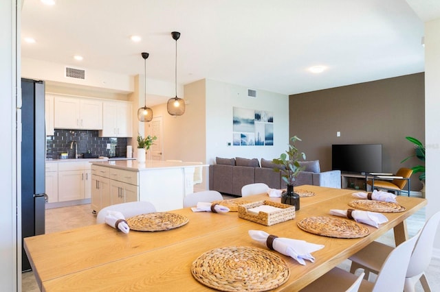 dining area with light tile patterned floors and sink