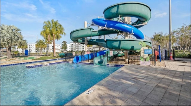 view of pool with a patio area and a water slide