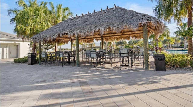 surrounding community featuring a gazebo, a pool, and a patio area