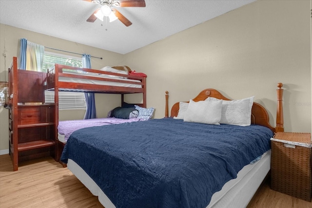 bedroom with ceiling fan, a textured ceiling, and light hardwood / wood-style floors