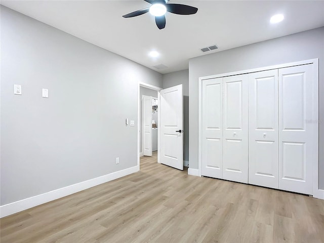 unfurnished bedroom featuring a closet, ceiling fan, and light hardwood / wood-style flooring