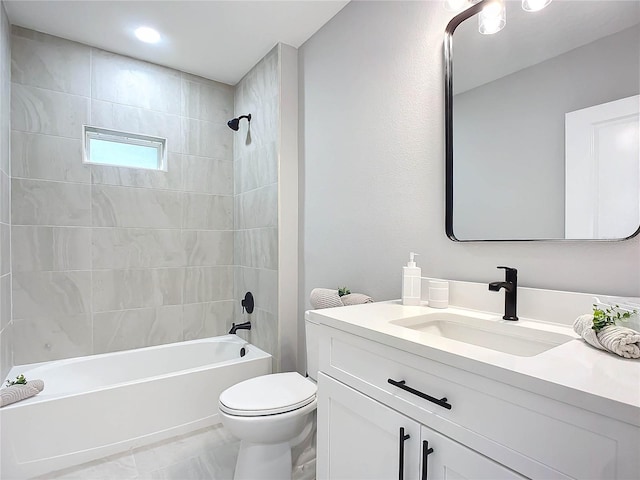 full bathroom with vanity, toilet, and tiled shower / bath