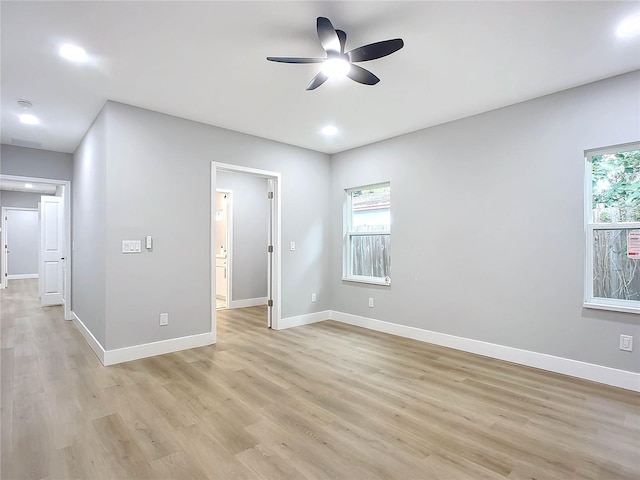 unfurnished room with a wealth of natural light, light hardwood / wood-style flooring, and ceiling fan