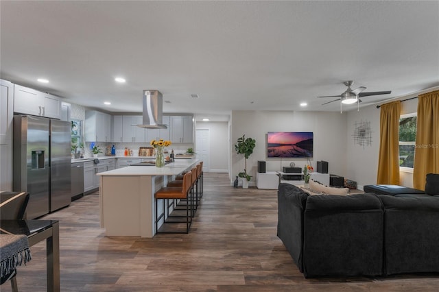 living room featuring dark wood-type flooring and ceiling fan