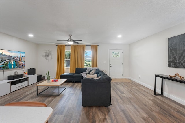 living room featuring ceiling fan and wood-type flooring