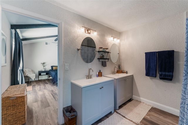 bathroom with vanity, a textured ceiling, and hardwood / wood-style flooring