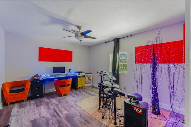 office with hardwood / wood-style floors, ceiling fan, and a textured ceiling