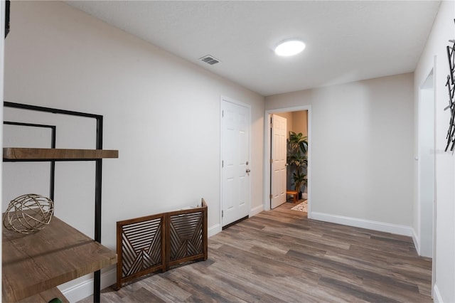 corridor featuring dark hardwood / wood-style flooring