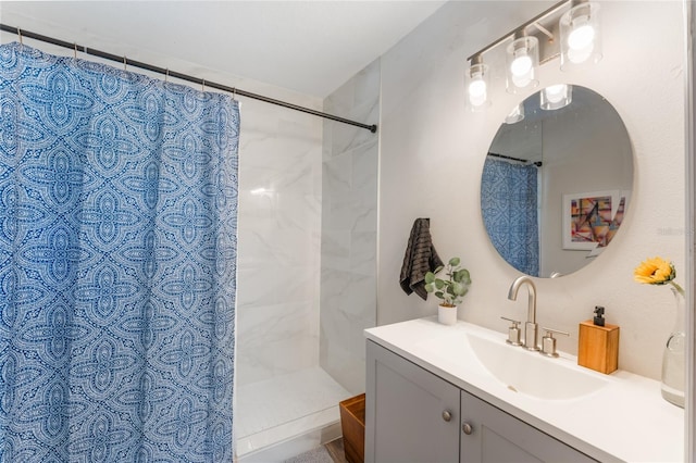 bathroom with walk in shower and vanity