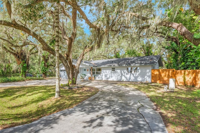 view of front of home featuring a garage and a front lawn