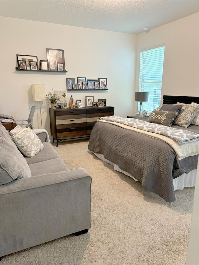 bedroom featuring a textured ceiling and carpet flooring