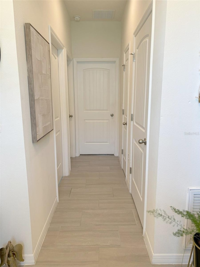 corridor with light hardwood / wood-style flooring