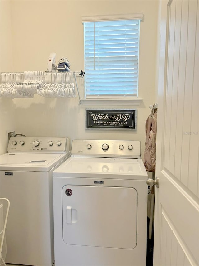 washroom with washing machine and clothes dryer