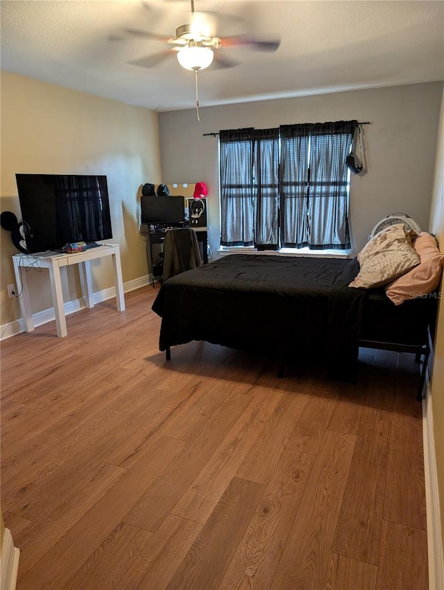 bedroom featuring ceiling fan and light hardwood / wood-style flooring