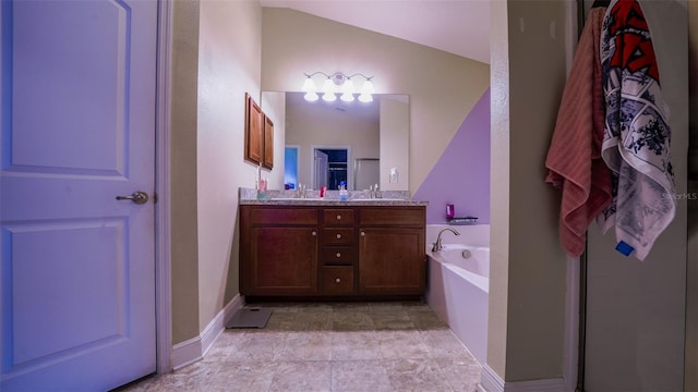 bathroom featuring lofted ceiling, vanity, and a bathtub