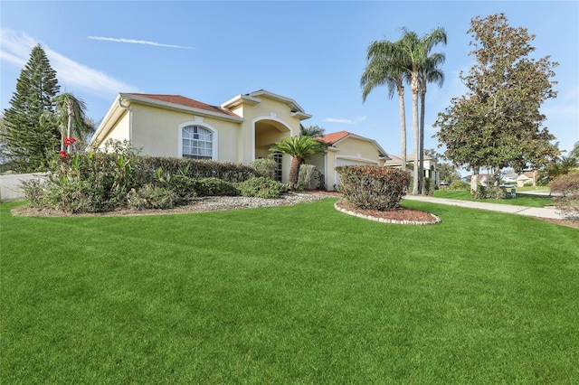 mediterranean / spanish house featuring a front lawn