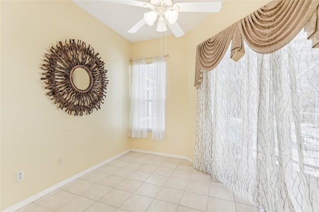 empty room featuring ceiling fan and light tile patterned flooring