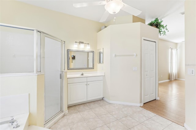 bathroom with an enclosed shower, vanity, hardwood / wood-style flooring, and ceiling fan