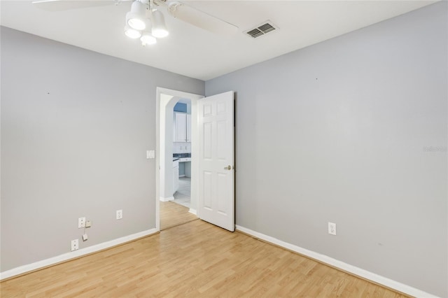 spare room with light hardwood / wood-style floors and ceiling fan