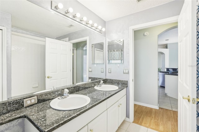 bathroom with hardwood / wood-style flooring and vanity