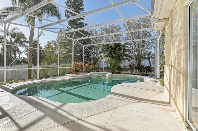 view of swimming pool featuring a lanai, an in ground hot tub, and a patio area