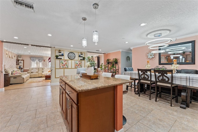 kitchen featuring a textured ceiling, light stone counters, decorative light fixtures, crown molding, and a notable chandelier