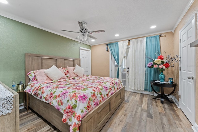 bedroom featuring a textured ceiling, access to exterior, ceiling fan, ornamental molding, and light hardwood / wood-style flooring