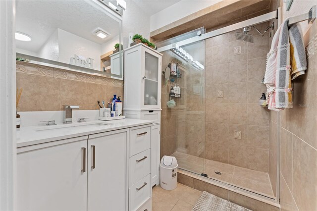 1395 Emerald Dr, Kissimmee, FL 34744 - bathroom with a shower stall, tile patterned flooring, and vanity