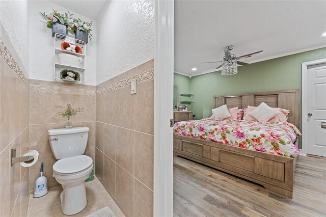 1395 Emerald Dr, Kissimmee, FL 34744 - bathroom featuring toilet, a textured wall, a ceiling fan, wood finished floors, and recessed lighting