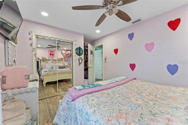 bedroom featuring a closet, wood-type flooring, and ceiling fan