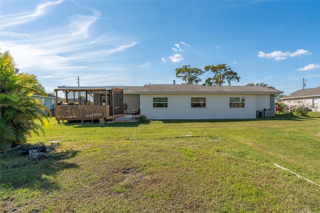 rear view of property featuring a yard