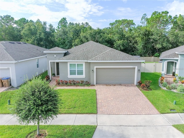 single story home with a front yard and a garage