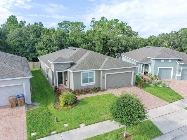 view of front of home with a front yard and a garage