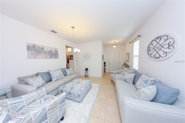 living room with a notable chandelier and light tile patterned floors