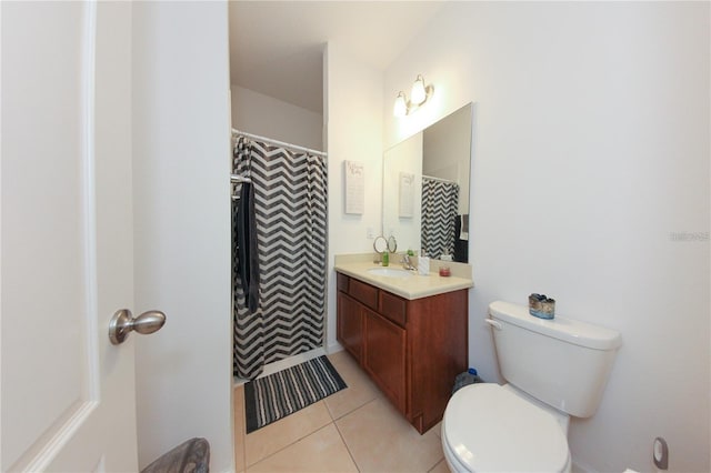 bathroom with vanity, toilet, and tile patterned flooring