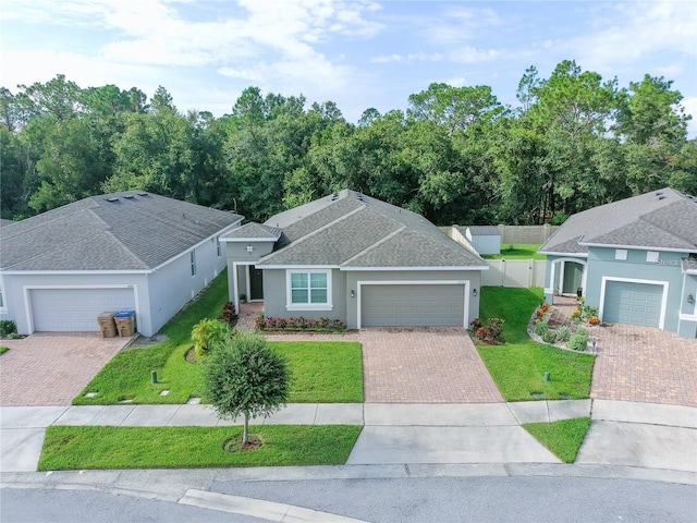 ranch-style home with a garage and a front lawn