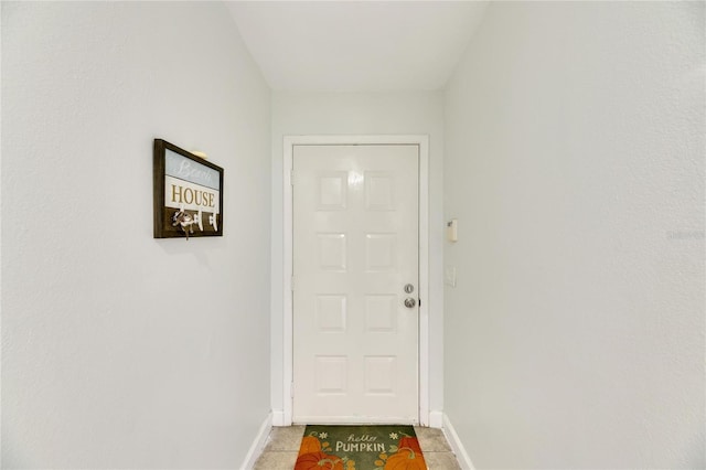 doorway to outside with light tile patterned floors